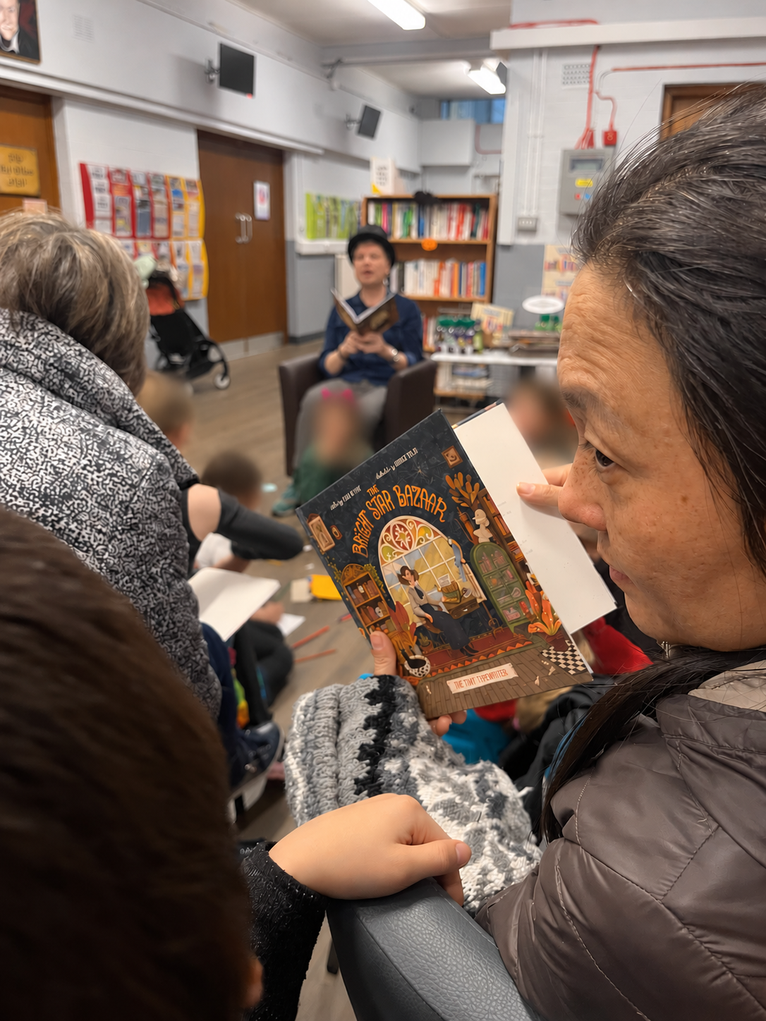 A guest holding The Tiny Typewriter during the reading